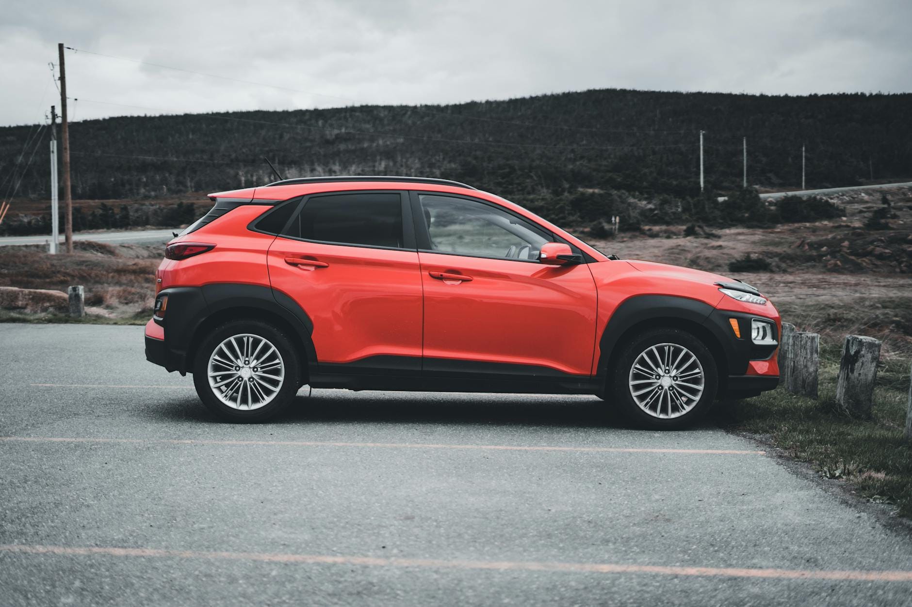 Czerwony Range Rover Evoque zaparkowany na zewnątrz w pochmurny dzień